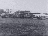 a black and white photo of a row of planes