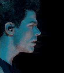 a close up of a man 's face wearing a pair of sony ear buds