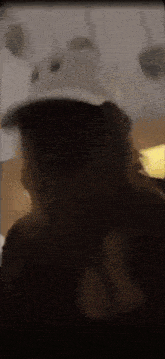a person wearing a hat with a bear on it