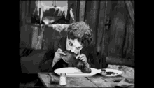Charlie Chaplin Eating Shoe GIF - Charlie Chaplin Eating Shoe GIFs