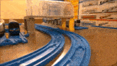 a toy train set is sitting on a table next to boxes of trains