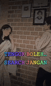 a man and a woman are standing in front of a brick wall with the words tengok boleh search jangan