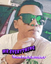 a man wearing green sunglasses and a headband with the words mr. everything quemexander