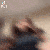 a blurry picture of a person 's face with a tiktok watermark
