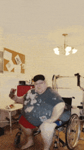 a man in a wheelchair is holding a bottle of soda