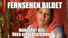 a woman is sitting in front of a plant with a caption that says fernsehen bildet