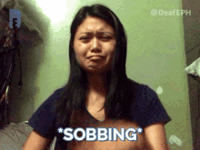 a woman with a sad look on her face says " sobbing " in front of her