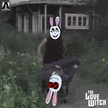 a poster for the love witch shows a cartoon rabbit