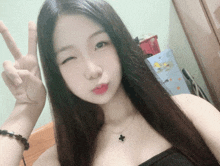 a woman giving a peace sign with her fingers