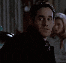 a man in a black coat says " yay "