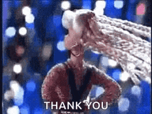 a woman is standing with her hands on her hips in front of a blue background and says `` thank you '' .