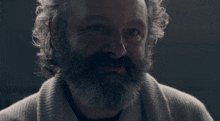 a man with a beard and curly hair looks at the camera with the hashtag itsscottiesstark