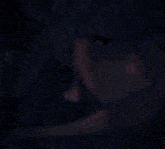 a close up of a person 's face with blue hair