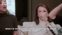 two women are sitting on a couch and one is asking what is the expiration date on these eggs