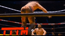 a man in a wrestling ring with the word tim in red