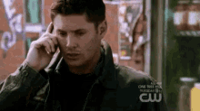 a man talking on a cell phone with the words one tree hill on the bottom right