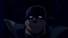 a man with a beard is wearing a black mask and smiling