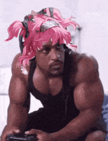 a man with pink hair is playing a video game .