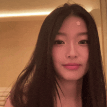 a woman with a star on her forehead looks at the camera
