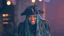 a woman with blue dreadlocks and a pirate hat