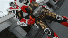 a person in a red and black costume with a belt that says ' r ' on it