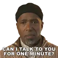 a man with a beard wearing a beanie and sweater says " can i talk to you for one minute "