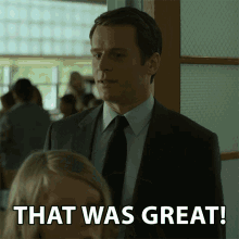 a man in a suit and tie stands next to a woman and says " that was great "