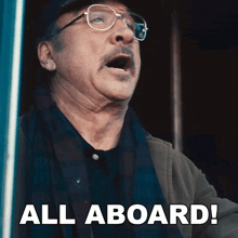 a man with glasses and a mustache is shouting all aboard