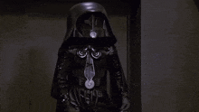 a darth vader holding a green light saber