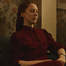 a woman in a red dress with her eyes closed
