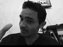 a man is giving a thumbs up in front of a tv