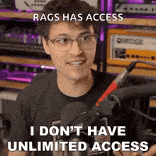 a man with glasses is standing in front of a microphone and saying rags has access i don 't have unlimited access