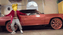a man in a red jacket is standing in front of a red car