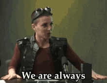 a woman sitting at a desk with the words we are always behind her