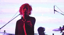 a person with pink hair is dancing in front of a mrtck logo