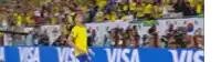 a man in a yellow shirt is walking in front of a sign that says visa on it .