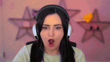 a woman wearing headphones with her mouth open