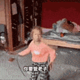 a little girl is dancing in a messy room with a sword in her hand .