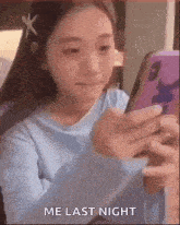 a girl is looking at her cell phone and says `` me last night '' .