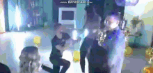a group of people are dancing in a room with the website www.bandicam.com visible in the corner .