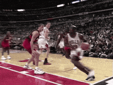 a basketball player in a bulls jersey is dribbling the ball
