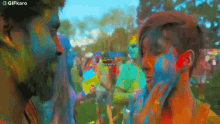 Put Color On Your Face Gifkaro GIF - Put Color On Your Face Gifkaro Playing With Colored Powder GIFs