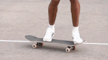 a man in a white tank top and black shorts is skateboarding