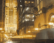 a busy city street at night with a building that says ' chicago ' on the top