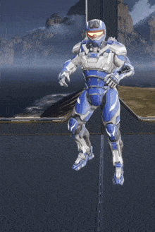 a man in a blue and white armor stands on a platform