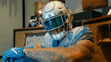 a football player wearing a helmet that says ucsd on it