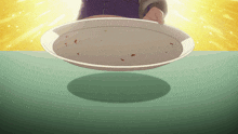 a person holding an empty plate on a green table