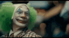 a close up of a clown with green hair and a hat .