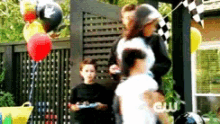 a group of people are standing in front of a sign that says cw on it
