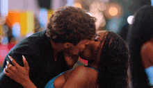 a man and a woman are kissing in a blurry photo
